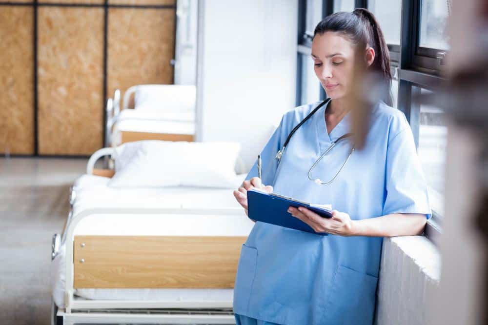 nurse assessing patient on clipboard